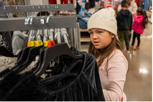 A child shopping for a dress at Garments of Love
